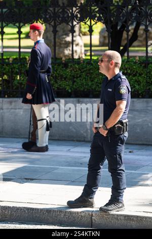 Evzone security guard and policeman on the street at the presidential palace, Athens, Greece Stock Photo