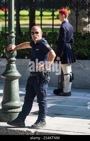 Evzone security guard and policeman on the street at the presidential palace, Athens, Greece Stock Photo