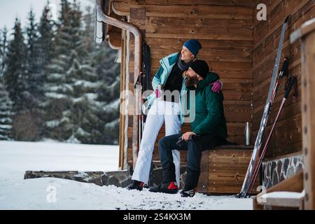Couple spending active Valentine's weekend in the mountains, doing winter sports. Cross-country skiing in the winter wilderness. Stock Photo