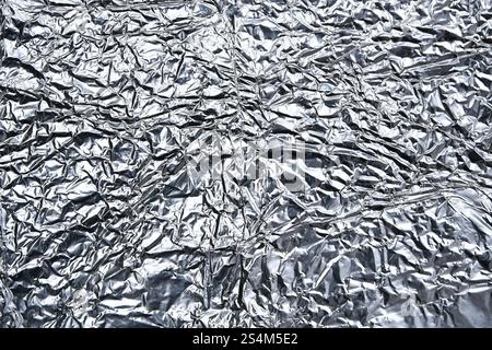 Foil crumpled textured metallic silver foil background Stock Photo