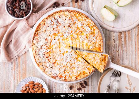 Homemade roasting apple cake with almonds and pudding filling with raisins Stock Photo