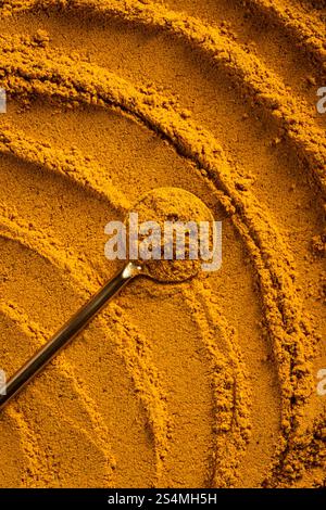A vibrant close-up of golden curry powder, showcasing its textured surface with swirling patterns This aromatic spice is perfect as an ingredient for Stock Photo