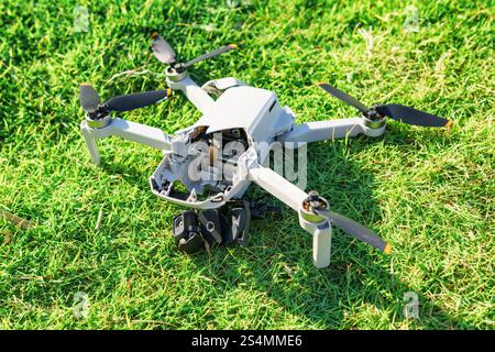 Accident with a drone. Damaged quadcopter on green grass Stock Photo