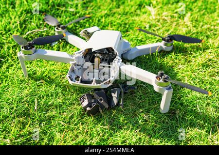Accident with a drone. Damaged quadcopter on green grass Stock Photo