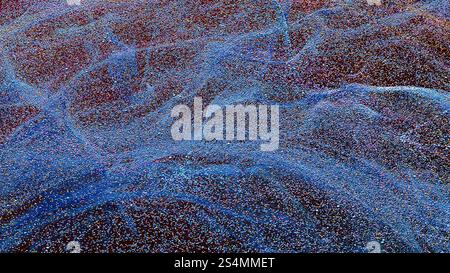 This captivating background showcases a dynamic array of particles in motion, creating a mesmerizing visual effect The rich colors and intricate patte Stock Photo