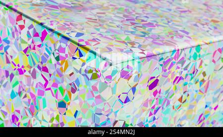 This digital artwork features a mesmerizing array of iridescent geometric patterns rendered in 3D, showcasing a smooth surface adorned with multicolor Stock Photo