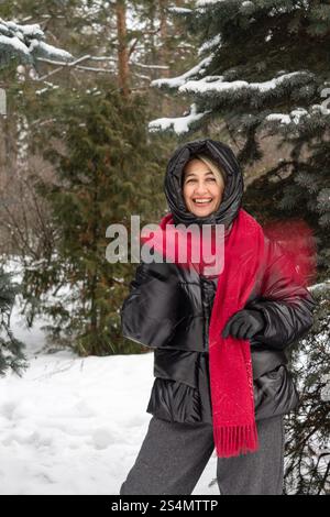 positive wpositive woman 50 years old, dressed in a black jacket Stock Photo