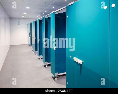 27-12-2024 Munich International Airport, Germany. Men's WC stalls inside terminal washroom, no people. Stock Photo