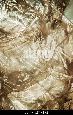 Texture of glossy polyethylene plastic sheet material crumpled and wrinkled from above Stock Photo