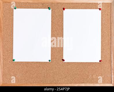 two white sheets of paper on cork board in wooden frame Stock Photo