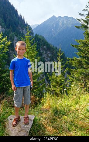Boy in summer mountain. View from Transfagarasan road (Romania) Stock Photo