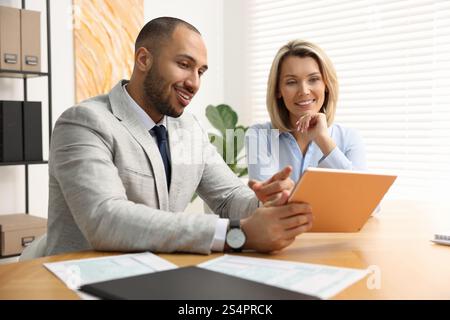 Coworkers with tablet working together in office Stock Photo
