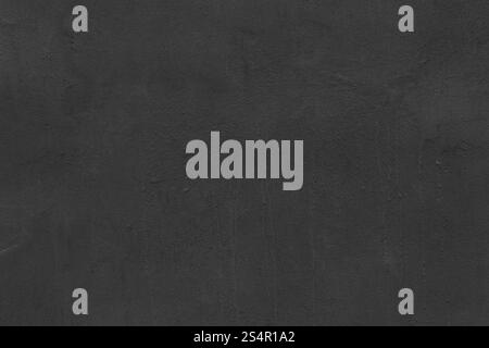 Textured gray concrete wall with dried streaks and uneven weathered surface. Close-up view of dark abstract industrial background Stock Photo