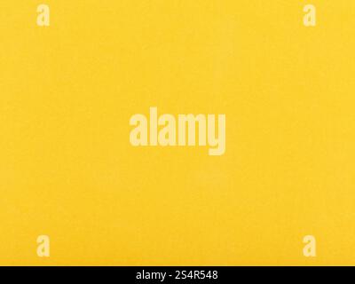 background from sheet of dark yellow color velvet paper close up Stock Photo