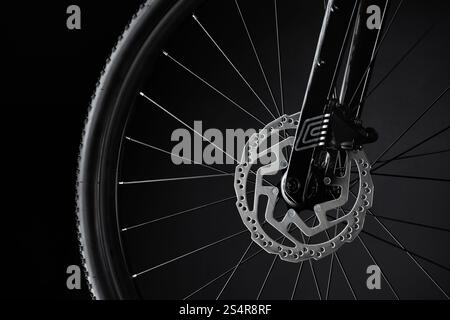 Close up of bicycle wheel, fork, brake disc on a black background. Cycle parts detailed. Stock Photo