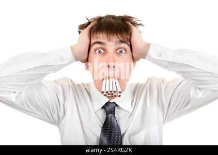 Shocked Young Man with Many Cigarettes in his Mouth. Isolated on the white background Stock Photo