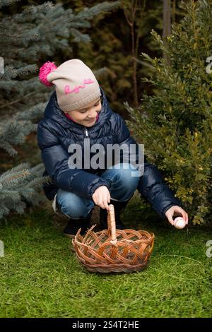 Little girl looking for Easter eggs at backyard Stock Photo