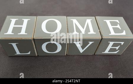 Closeup photo of words love and home written on wooden bricks Stock Photo