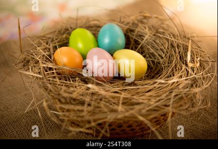 Five Easter eggs lying on table at nest Stock Photo