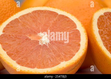 Close-up view of orange fruit slices, showcasing their juicy texture and vibrant color. The image highlights the details of the orange segments and th Stock Photo