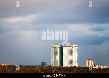 dark gray rainy clouds over urban houses before rain in spring day Stock Photo