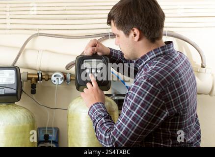 Portrait of engineer checking pressure meters at factory Stock Photo