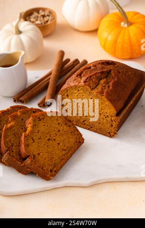 Pumpkin bread freshly baked sliced on a serving board, Thanksgiving dessert idea Stock Photo