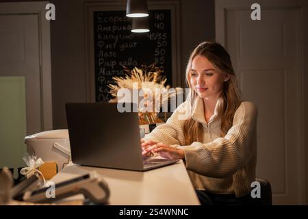 Woman in coffee shop small business owner, entrepreneur in cafeteria. Happy female businesswoman working on cafe franchise. Stock Photo