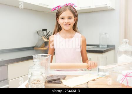 Portrait of cute girl learning culinary on kitchen Stock Photo