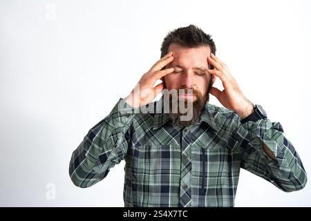 Upset man standing with his hand holding his forehead Stock Photo