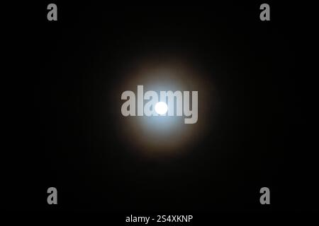 Circle around the Moon, a moon halo. Stock Photo