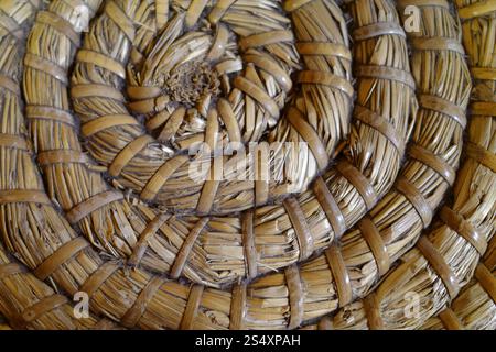 Detail of a bottom of a handmade straw basket Stock Photo