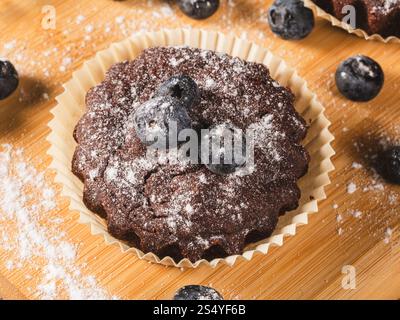 Blueberry muffin on kitchen table, top view, extreme close up. Stock Photo
