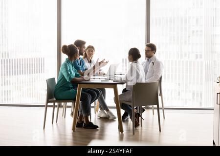 Five multiethnic medical workers take part in meeting Stock Photo