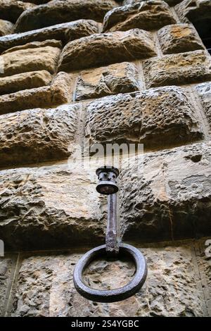 travel to Italy - ring of hitching post on wall of medieval house on street in Florence city Stock Photo