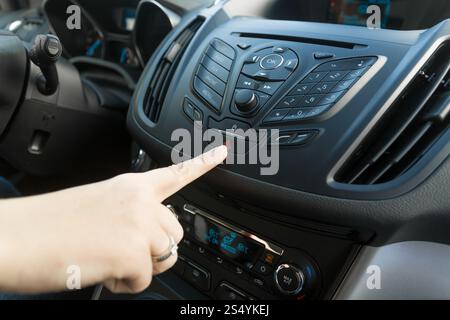Closeup of woman pressing red car emergency button Stock Photo