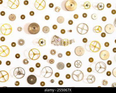 watchmaker workshop - pattern from various used watch spare parts on white background Stock Photo