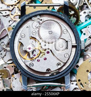 watchmaker workshop - mechanical clockwork on heap of clock spare parts Stock Photo