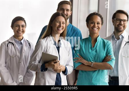 Multiethnic millennial healthcare team posing together in clinic Stock Photo