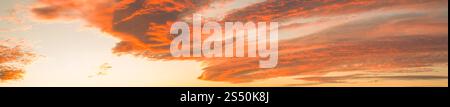 Panoramic orange sky. Red view of the clouds after sunset or sunrise  in the evening. Calm atmosphere in the evening. Stock Photo