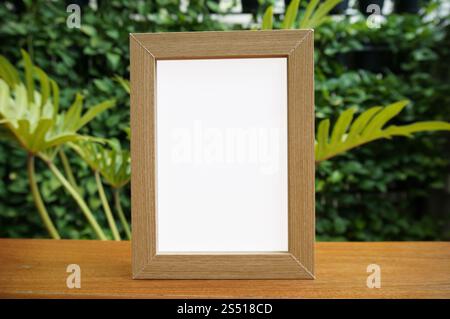 Mock up Blank white frame standing on wood table in Bar restaurant cafe. space for text. product display montage Stock Photo