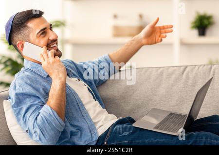 Portrait of positive israeli man talking on phone at home Stock Photo