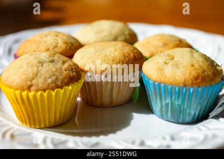 Mini banana muffins sit on a white plate. Stock Photo