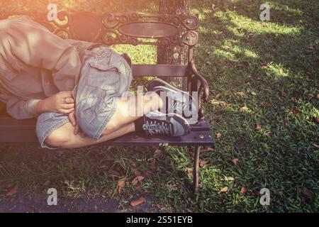 Homeless man sleeping in a park bench Stock Photo - Alamy
