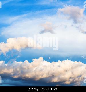 white and gray cumuli clouds in dark blue sky over Moscow in summer evening Stock Photo