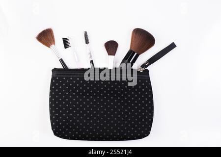 Makeup Brushes in comestic bag isolated on white background. Stock Photo