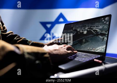 Israel IDF military personnel working on laptop, analyzing aerial reconnaissance data to come up with warfare winning tactics. Close up shot of notebook used to control drones attacking strategic targets Stock Photo