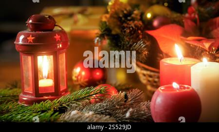 Closeup photo of burning candles and lantern on Christmas eve. Closeup image of burning candles and lantern on Christmas eve Stock Photo