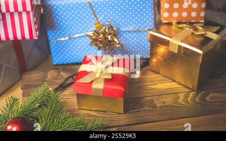 Closeup photo of colorful Christmas gift boxes and present on wooden background. Closeup image of colorful Christmas gift boxes and present on wooden Stock Photo