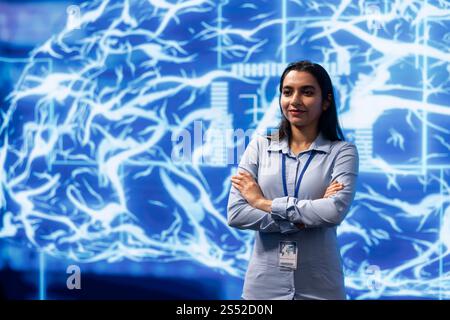 Portrait of cheerful admin using artificial intelligence computing simulating human brain. Smiling programmer working with AI machine learning algorithms in modern workspace Stock Photo